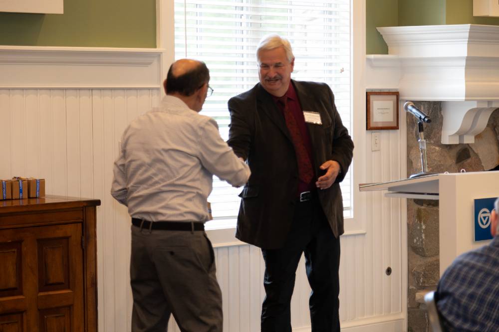 Dean Plotkowski shaking hands with retiree